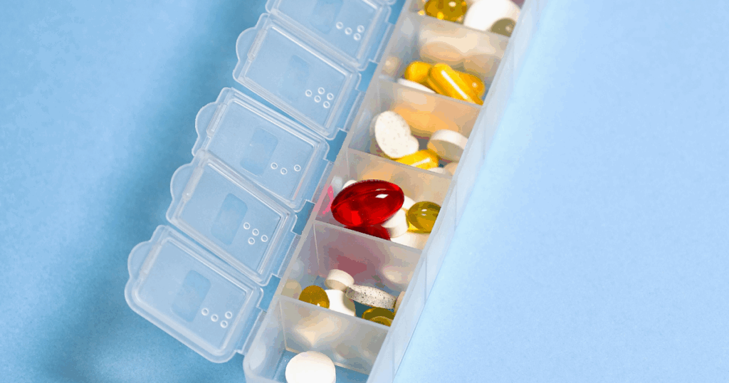 Pill organizer with various medications Comparing Buspirone and Xanax dosage and effects Medication management for anxiety treatment