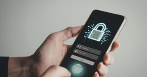 Smartphone screen showing a glowing padlock username and password fields a login button and a fingerprint icon for biometric authentication