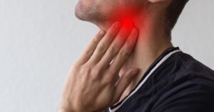 Man clutching his neck with a red glow around the throat suggesting pain or sore throat