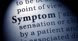 Close up of a dictionary page with the word Symptom in bold type highlighting medical terminology