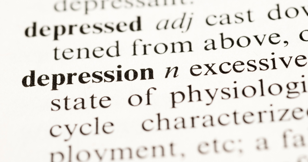 Close up of a dictionary page with the word depressed and related definitions visible in boldnormal type